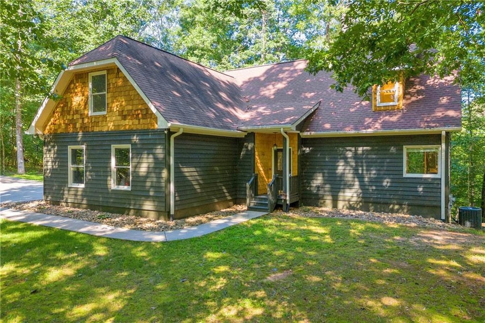 View of front of home featuring a front lawn and c