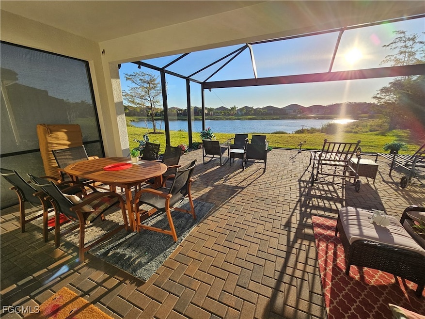 Sunroom featuring a water view