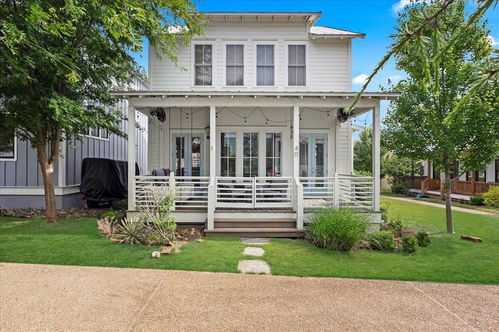 View of front of home featuring a porch, a front lawn, and french doors