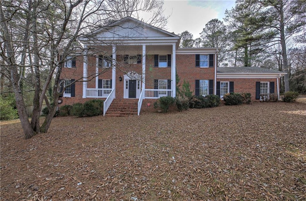 Greek revival inspired property featuring covered 