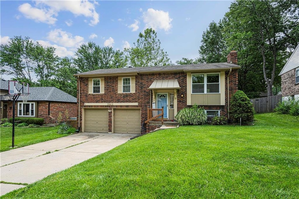 Raised ranch with a garage and a front yard