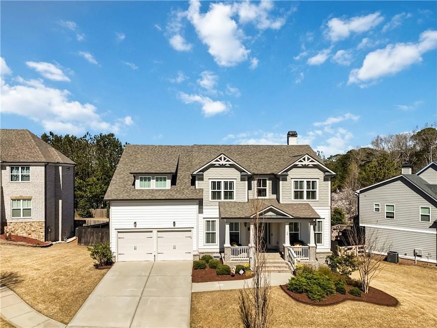 Traditional-style home with a shingled roof, drive