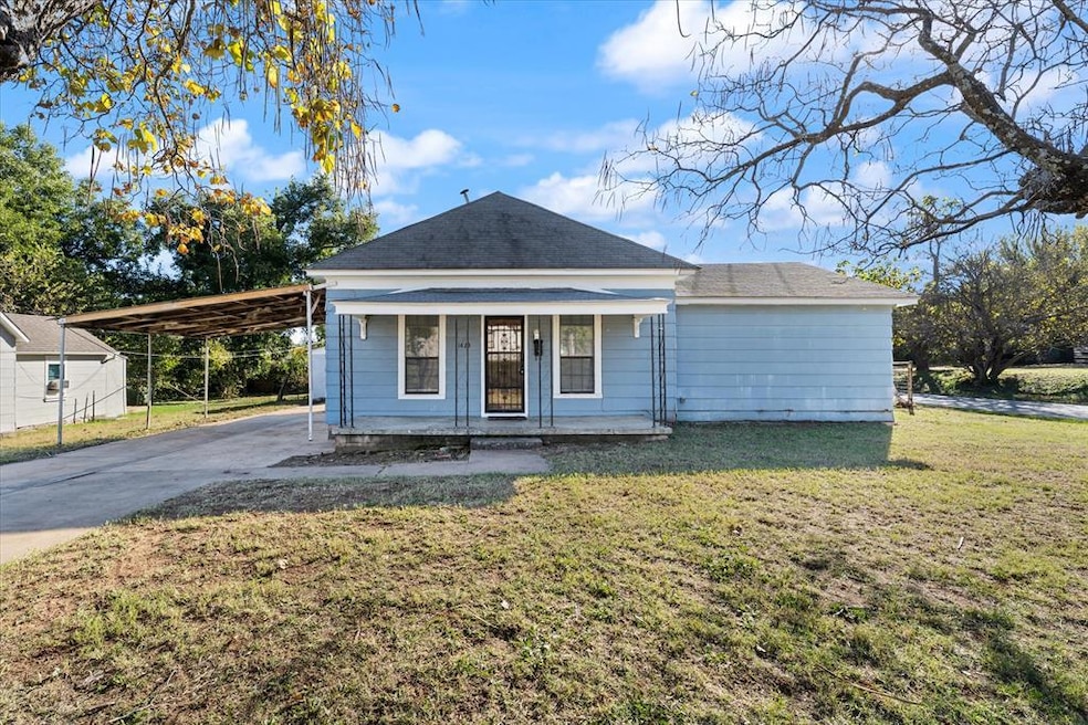 View of front of home with a front yard, a porch, and concrete driveway