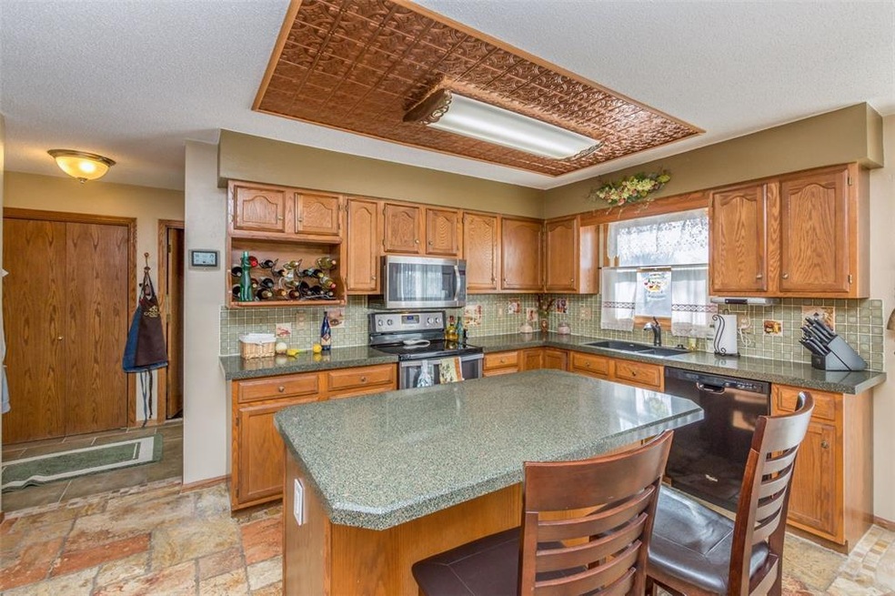 View of kitchen, granite countertops, tiled floor 