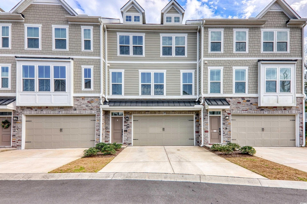 Multi unit property featuring stone siding, drivew