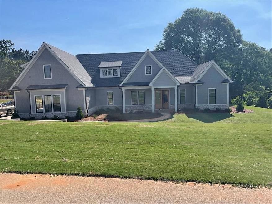 View of front of property with a front yard and st