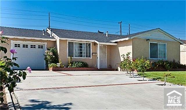 Well maintained front landscape and white picket n