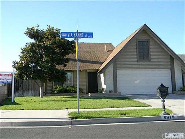 Corner house with concrete RV pad to the right and