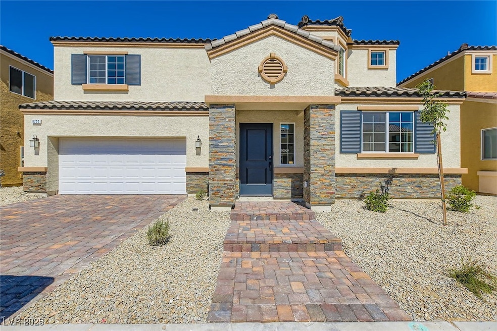 View of front of house with a tile roof, stucco si