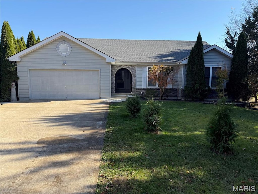 Single story home with driveway, a front lawn, an attached garage, and roof with shingles