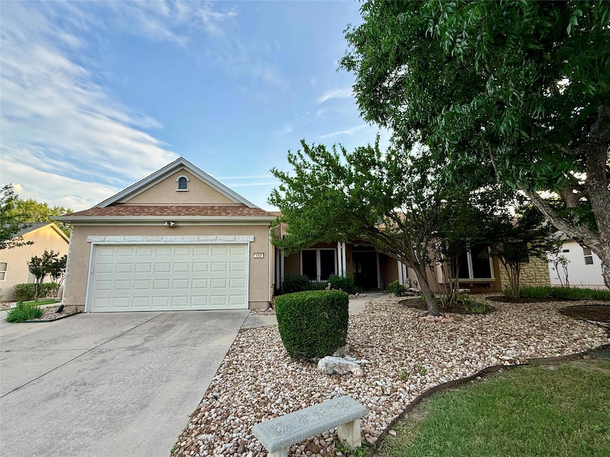Single story home with concrete driveway, stucco 