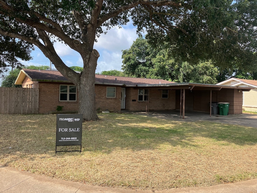 This brick home offers a beautiful tree and tons o