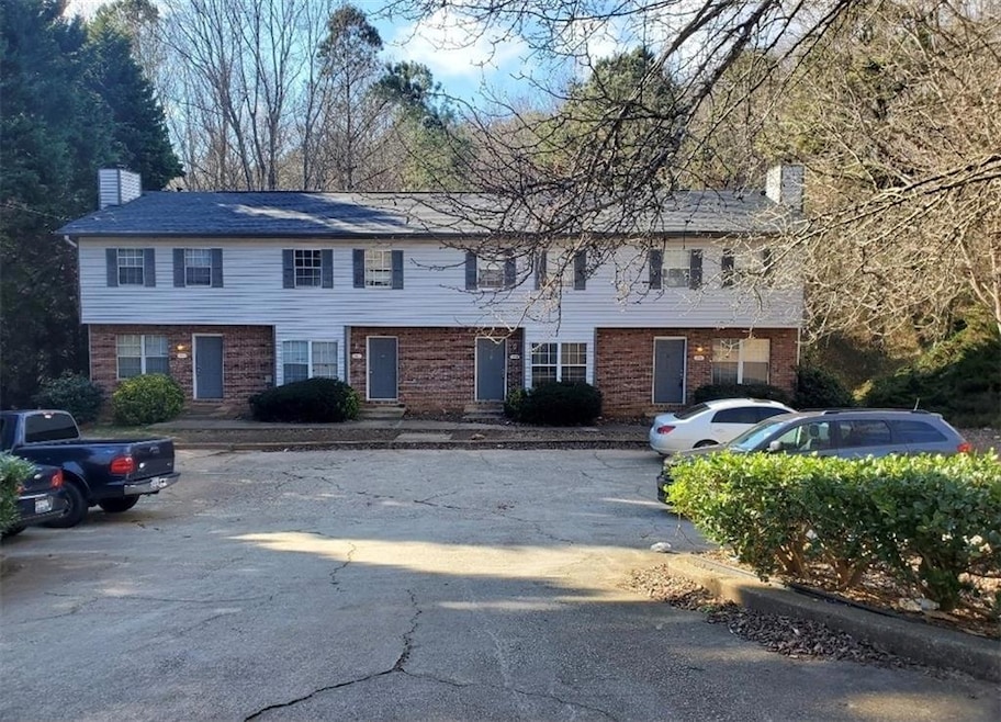 Multi unit property with a chimney and brick siding