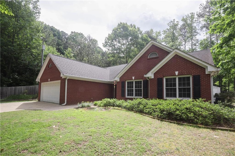 Single story home featuring brick siding, an attac
