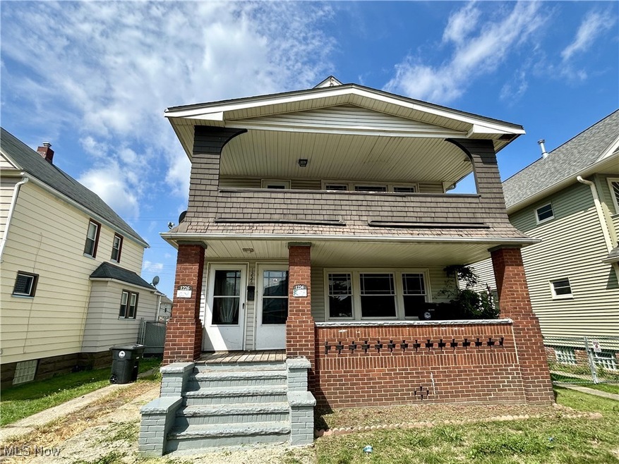 View of front of property with a balcony and a porch