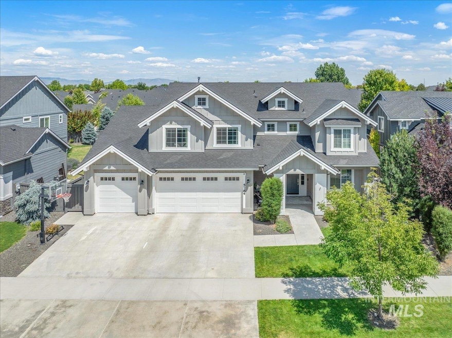 View of front of property featuring board and batten siding, concrete driveway, a residential view, roof with shingles, and an attached garage