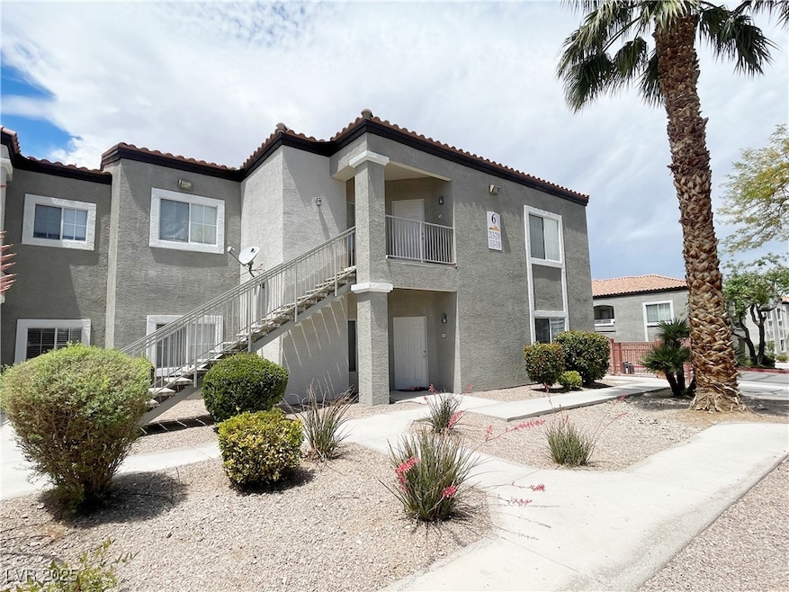 View of front facade featuring stucco siding, a ti