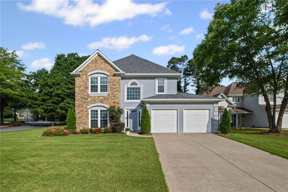 Traditional home featuring concrete driveway, two car garage, hardi-plank, stone and hard coat stucco.