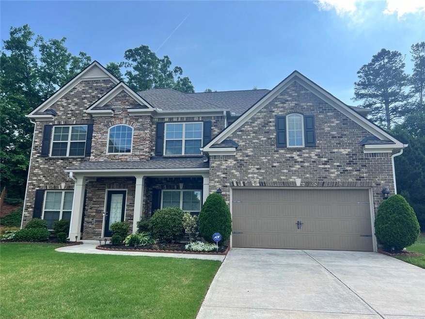 Craftsman-style home with a front yard and a garag