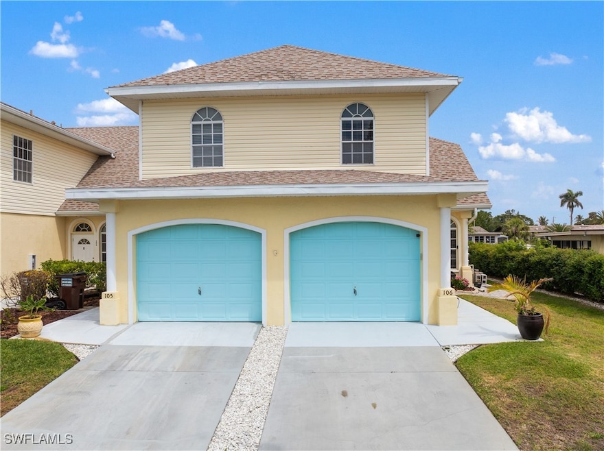 Traditional-style townhouse featuring driveway, si