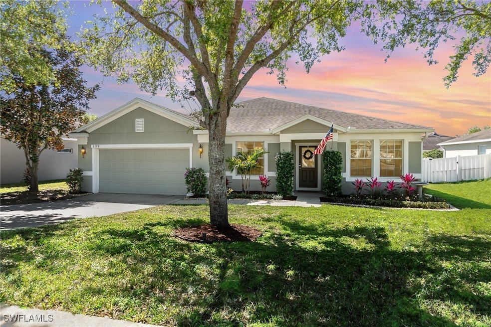 Ranch-style home featuring fence, a garage, concre