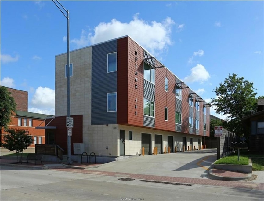 View of building exterior with concrete driveway a