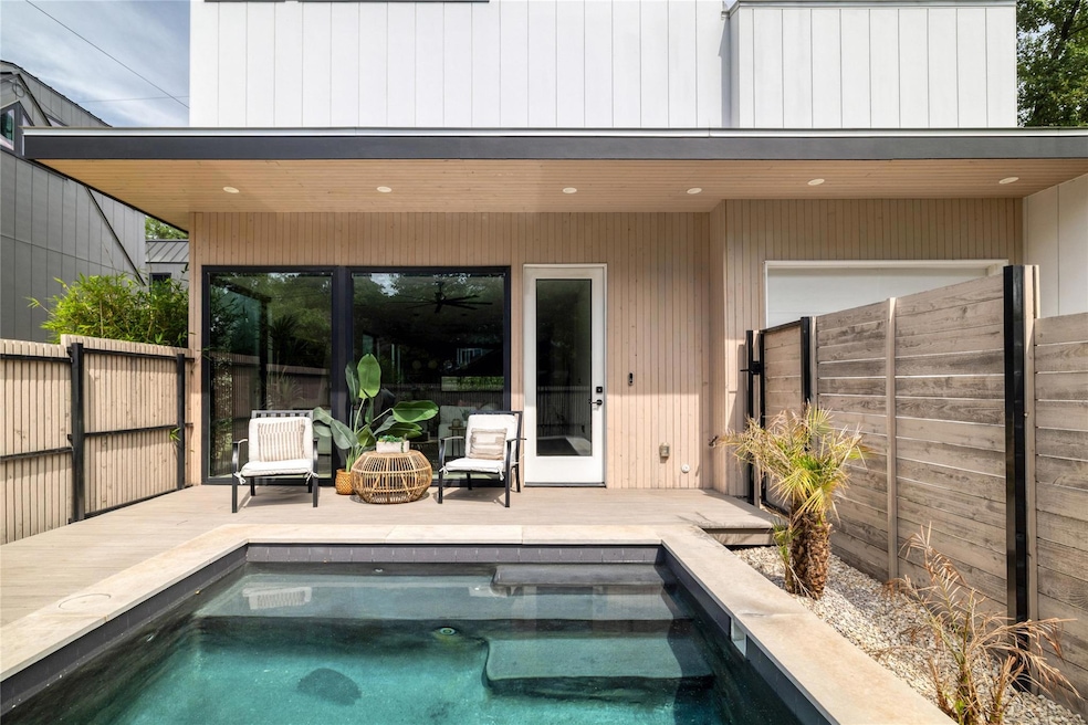 Rear view of property featuring a fenced backyard