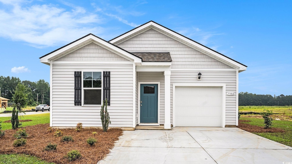 View of front of home with driveway, a garage, and a shingled roof