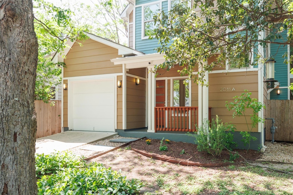 Traditional-style house with fence, covered porch