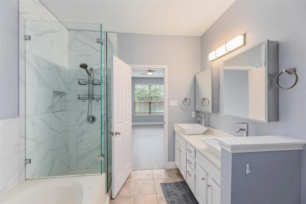 Full bath featuring a marble finish shower, ceili