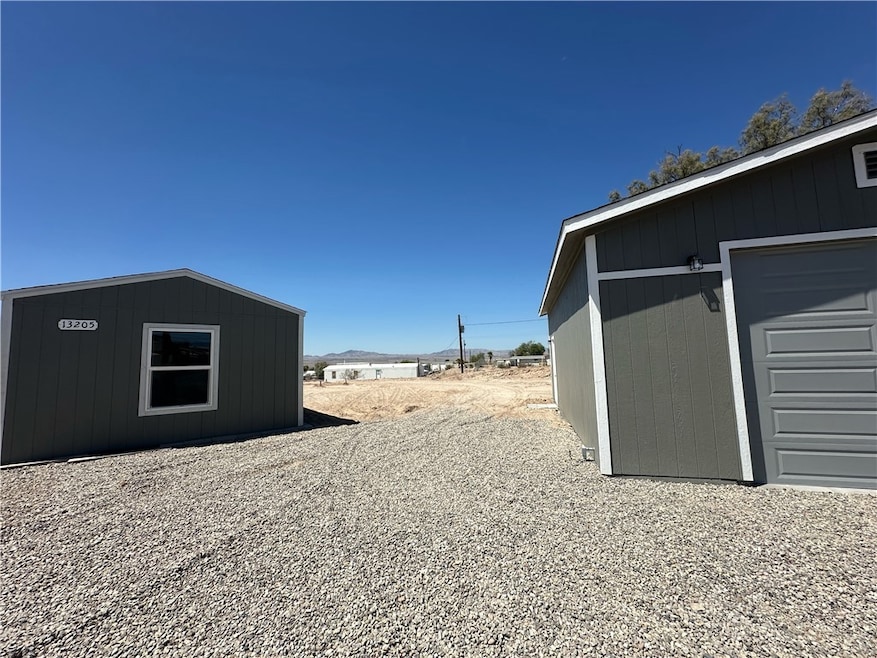 View of yard featuring an outbuilding, a garage, and a mountain view