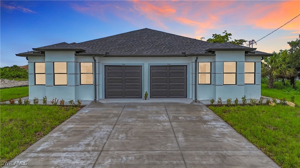 View of front facade featuring stucco siding, an a