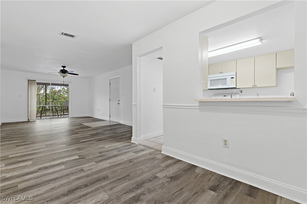 Unfurnished living room with hardwood / wood-style
