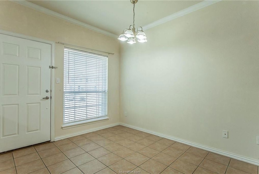 Unfurnished dining area featuring crown molding, a