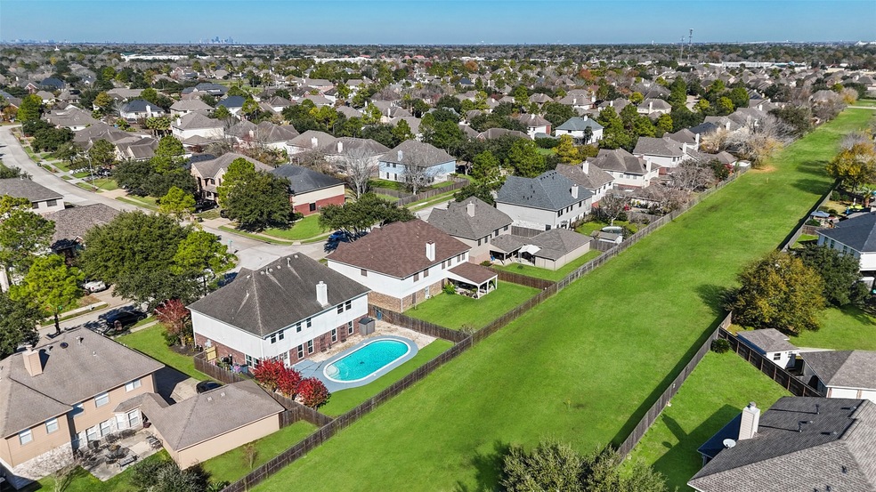 Welcome to 3721 Pinehurst Drive in east Pearland's Pine Hollow community! An aerial view of the home highlights the pool, the fabulous backyard retreat, the privacy from the green belt, and the pride of ownership that shines in the well-kept surrounding homes that will be your new neighbors in Pine Hollow!