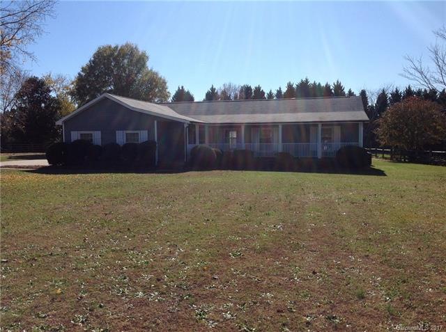 large flat lot with rocking chair front porch