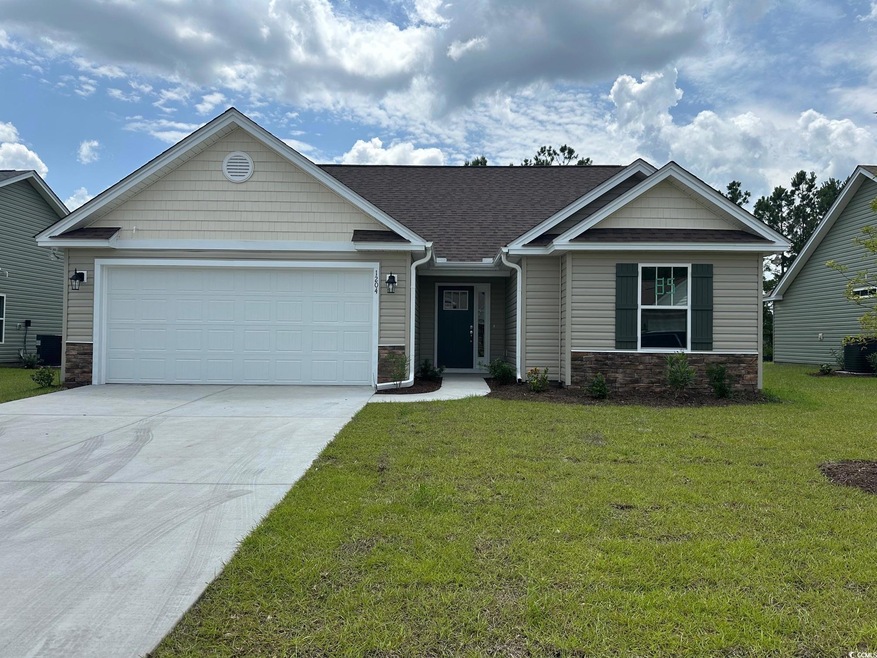 View of front of house featuring driveway, stone s