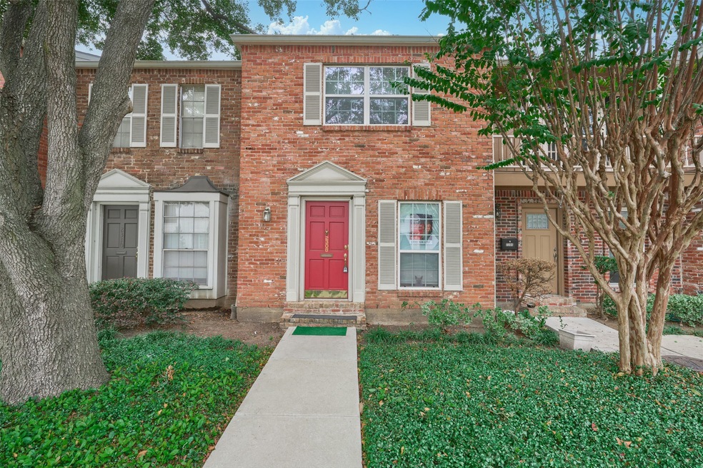Charming two-story brick townhouse with a striking