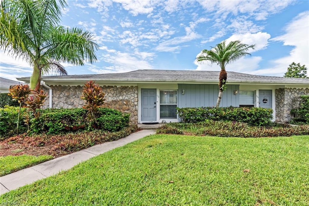 Villa style home with a front yard