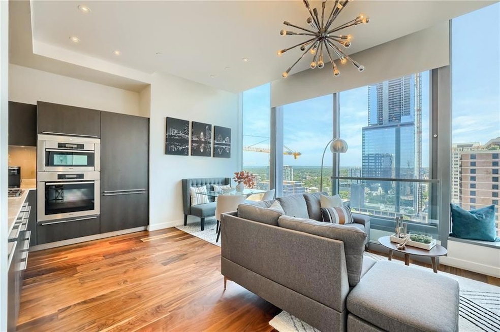 Living room with a view of city, baseboards, ligh