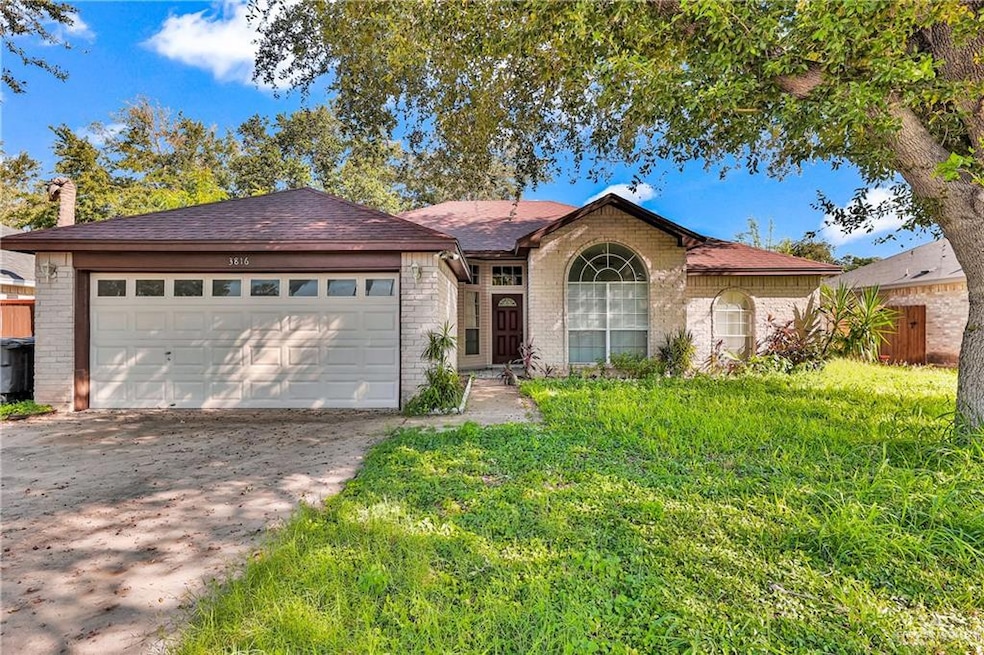 Ranch-style home featuring brick siding, driveway, roof with shingles, and an attached garage