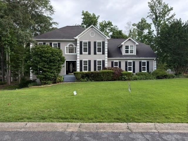 View of front of property with a front lawn