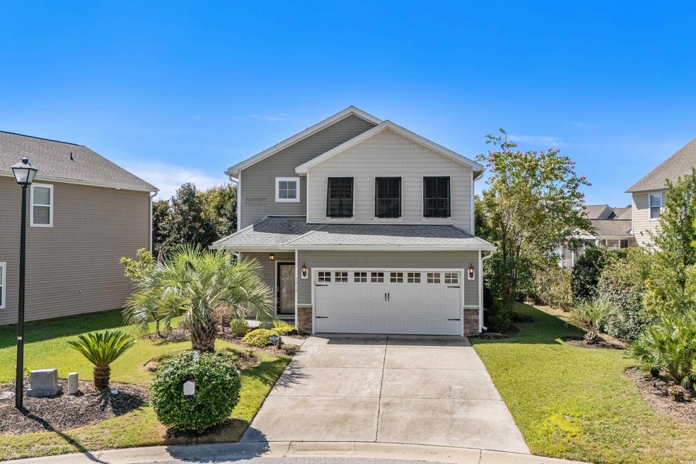 View of property with a garage, central AC, and a 