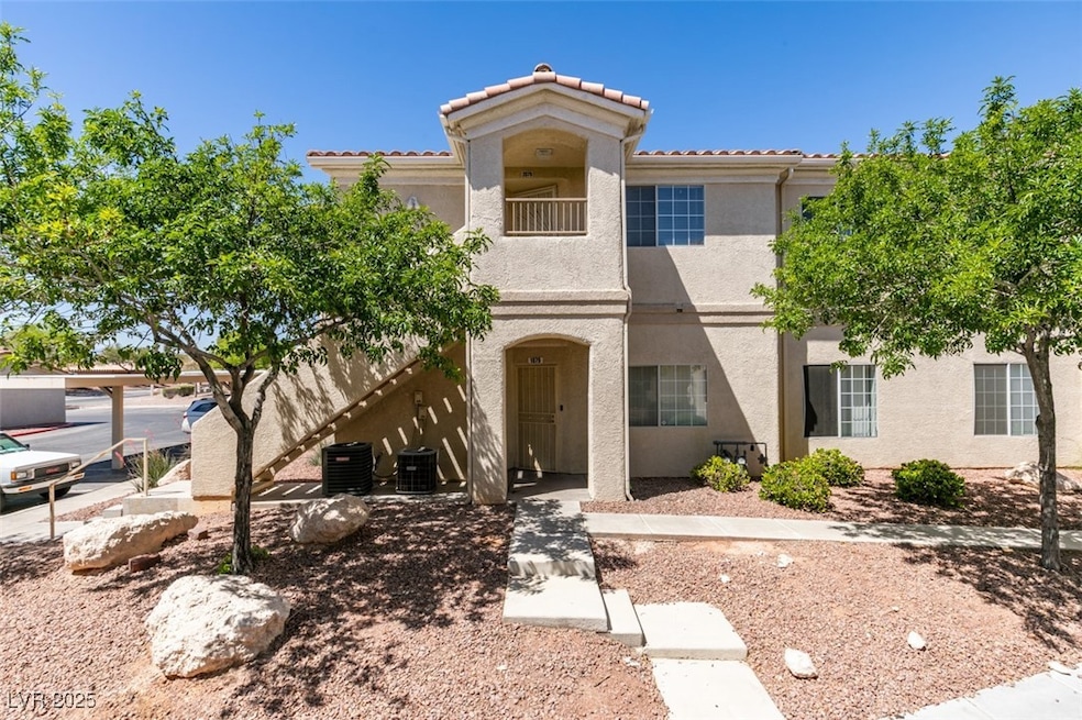 Mediterranean / spanish house featuring a balcony, stucco siding, and stairs