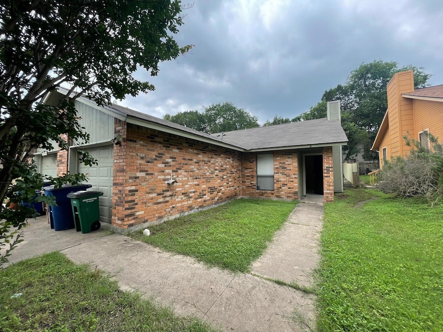 View of front of house with brick siding, an attached garage, a front yard, a chimney, and roof with shingles