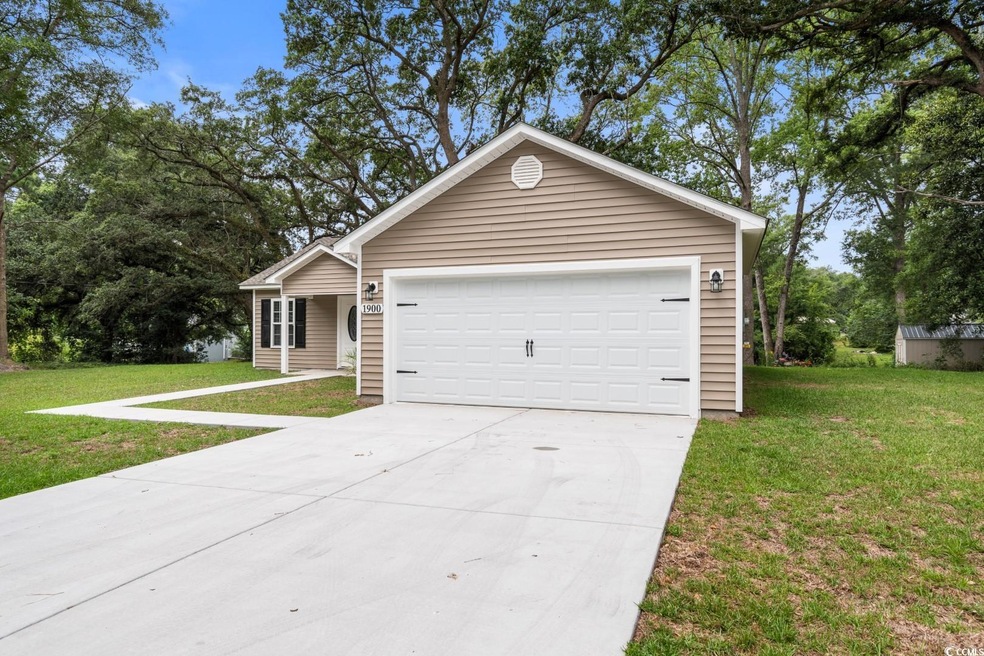 Single story home with a garage and a front yard