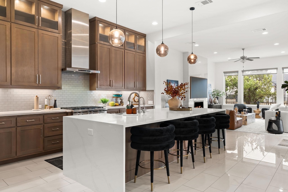Kitchen with tasteful backsplash, wall chimney ra