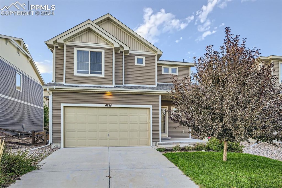 View of front facade featuring a garage