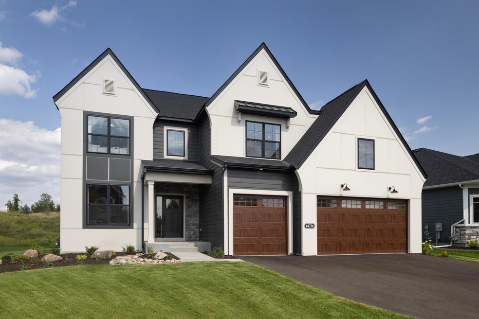 The beautifully upgraded exterior features black framed windows, 8' wood grain garage doors and an upgraded landscaping package with irrigation!