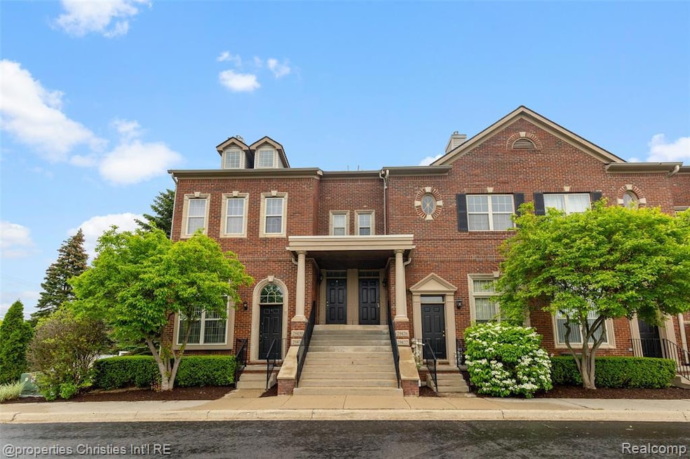 View of front of house with brick siding and a chimney